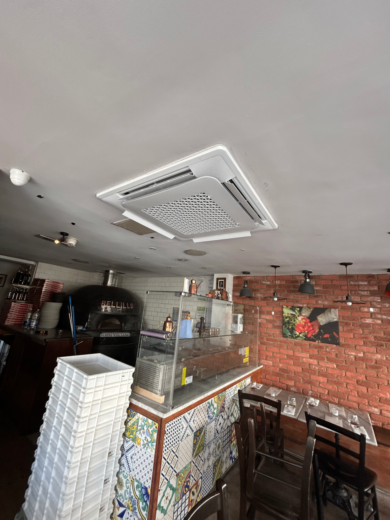Commercial cassette air conditioning unit installed in a restaurant ceiling